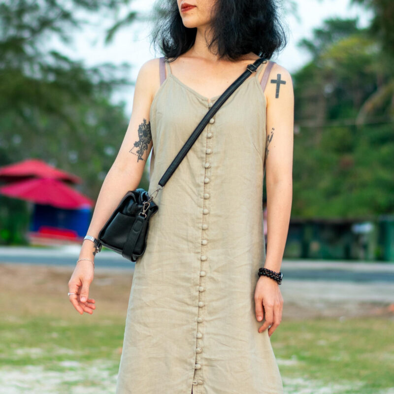 This sleeveless linen dress flows effortlessly with a natural drape, crafted from breathable fabric in an earthy beige tone. A full-length row of matching fabric buttons adds a subtle, handcrafted charm. Perfect for beach strolls or slow afternoons, this piece speaks of simplicity and thoughtful design.