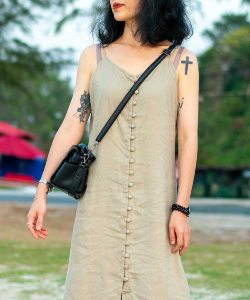 This sleeveless linen dress flows effortlessly with a natural drape, crafted from breathable fabric in an earthy beige tone. A full-length row of matching fabric buttons adds a subtle, handcrafted charm. Perfect for beach strolls or slow afternoons, this piece speaks of simplicity and thoughtful design.