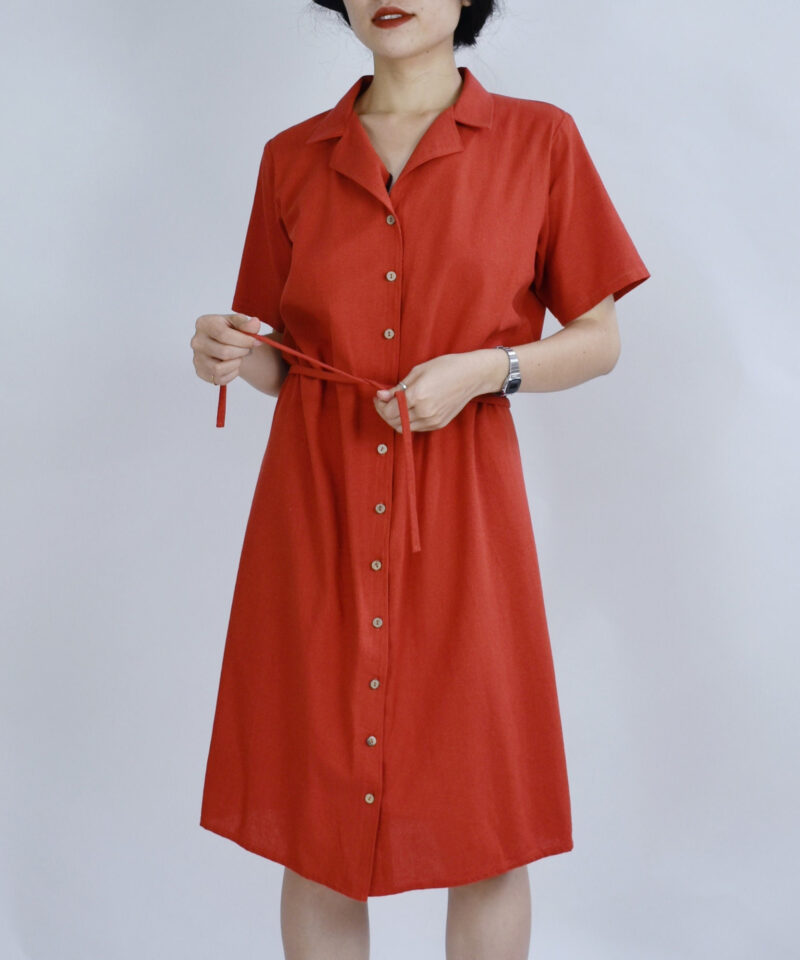 Crafted from breathable linen-blend fabric, this short-sleeve shirt dress in earthy red brings effortless charm to everyday wear. The pointed collar and full button front add a structured touch, while the waist tie defines your silhouette with a gentle cinch. A calm piece inspired by sun-warmed terracotta and natural ease.