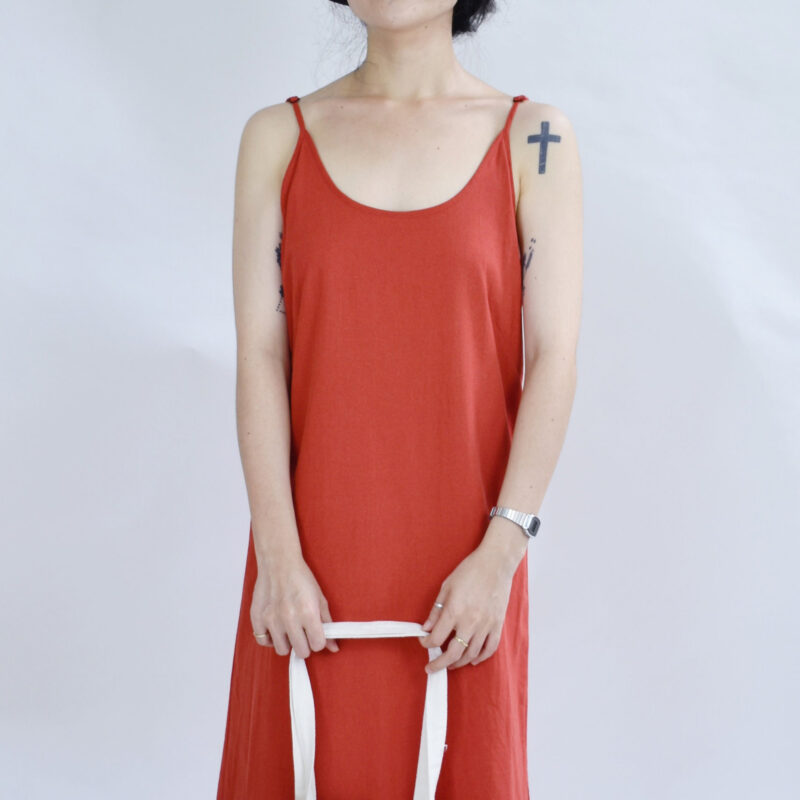Breezy and bold, this open-back red linen slip dress is crafted from soft, breathable fabric that floats effortlessly. The plunging V-back design adds a touch of quiet sensuality, perfect for summer strolls or beachside days. Lightweight and flowy, it captures the essence of carefree elegance.