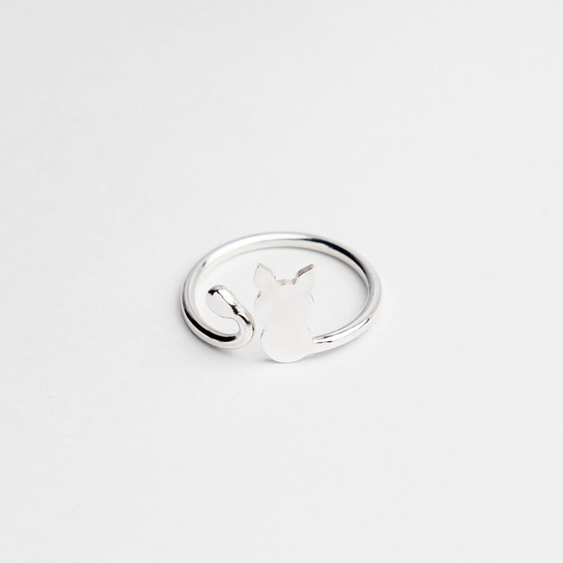 Adorable open band cat ring crafted from 925 sterling silver, showcasing a sleek cat outline with pointy ears and curled tail. The polished finish enhances its modern charm while celebrating feline grace. A lovely gift for pet lovers or anyone who treasures meaningful minimalist accessories.