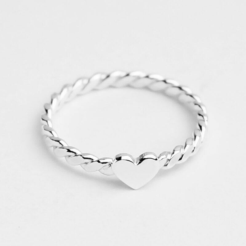 A dainty twisted band ring crafted from 925 sterling silver, featuring a polished heart centerpiece that adds a romantic charm. The delicate rope-style texture reflects soft light, highlighting its minimal yet eye-catching elegance. Perfect as a stacking ring or a sweet everyday reminder of love. This minimalist heart ring suits all styles and is ideal for gifting to someone special.