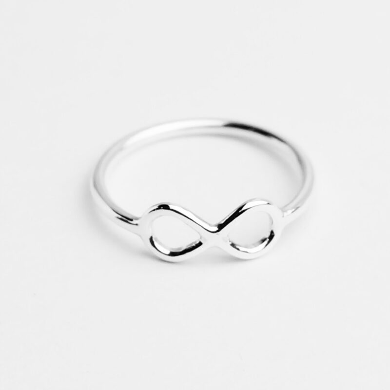Minimalist infinity ring handcrafted in 925 sterling silver, featuring a sleek and delicate infinity symbol centered on a slim polished band. Designed as a meaningful representation of eternal love and endless connection, this simple piece shines softly with a mirror-like finish. Ideal for everyday wear or gifting, it embodies elegance, subtle symbolism, and modern sentimentality.