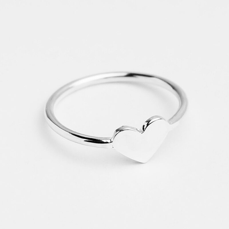 Delicately crafted in 925 sterling silver, this minimalist heart ring features a smooth, polished surface that reflects the light with subtle elegance. The petite heart detail at the center symbolizes pure affection and simplicity, making it a versatile everyday piece. Ideal for gifting or self-love, the ring’s clean, modern silhouette suits any style and serves as a meaningful reminder of love in its most sincere form.