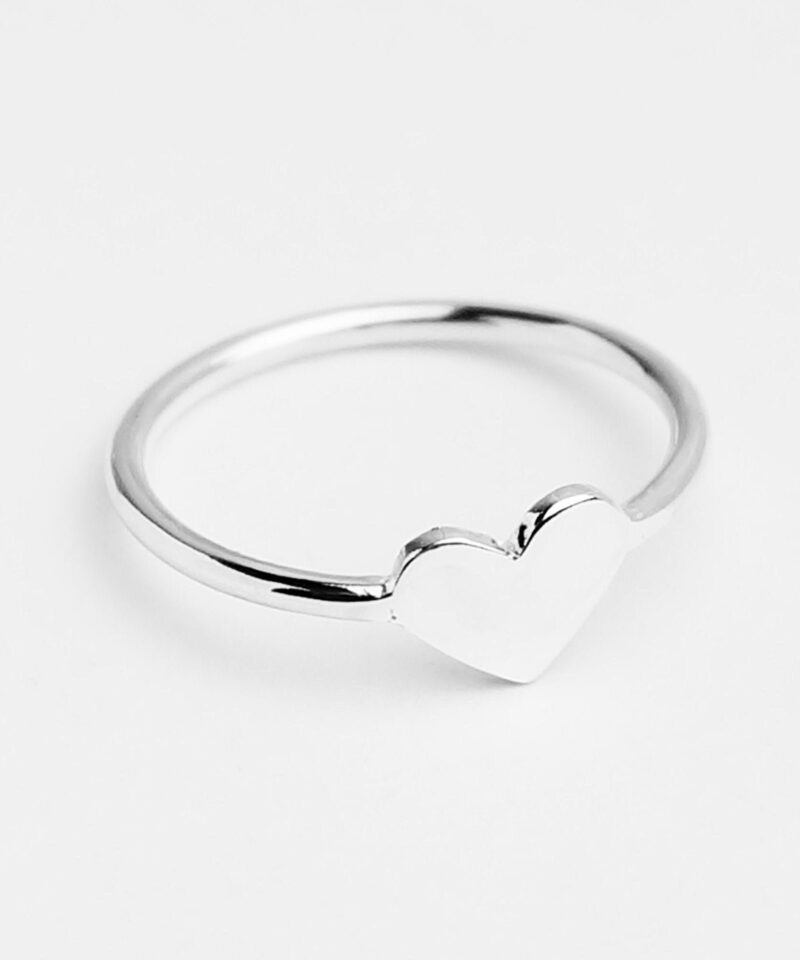 Delicately crafted in 925 sterling silver, this minimalist heart ring features a smooth, polished surface that reflects the light with subtle elegance. The petite heart detail at the center symbolizes pure affection and simplicity, making it a versatile everyday piece. Ideal for gifting or self-love, the ring’s clean, modern silhouette suits any style and serves as a meaningful reminder of love in its most sincere form.