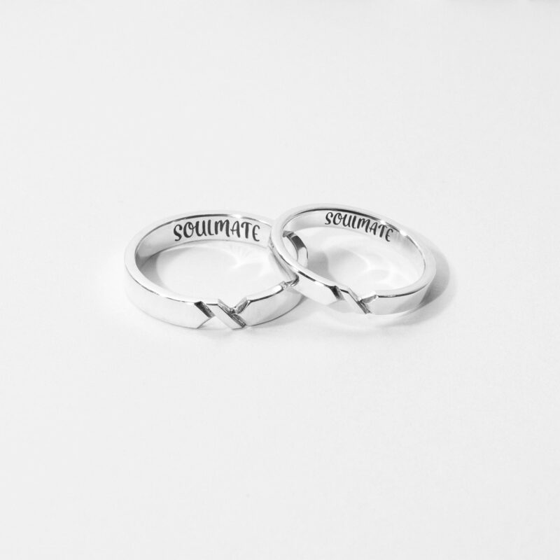 Two minimalist sterling silver couple rings with a connecting V-line detail, elegantly crafted to symbolize an unbreakable bond. These matching rings feature a sleek, polished finish and a subtle notch design that aligns when placed side by side. A meaningful choice for couples, soulmates, or best friends celebrating a special connection. Captured on a clean, white background for a bright, timeless feel.