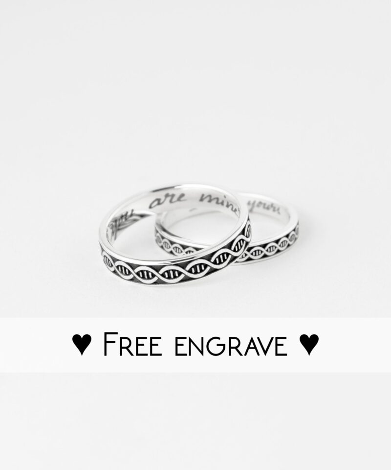 Studio shot of the DNA pattern silver couple rings placed together with “Free Engrave” text overlay. The focus is on the crisp, oxidized design and clean polish of each ring. Personalized engraving inside adds extra meaning, making them a perfect custom gift for anniversaries or promises between lovers.