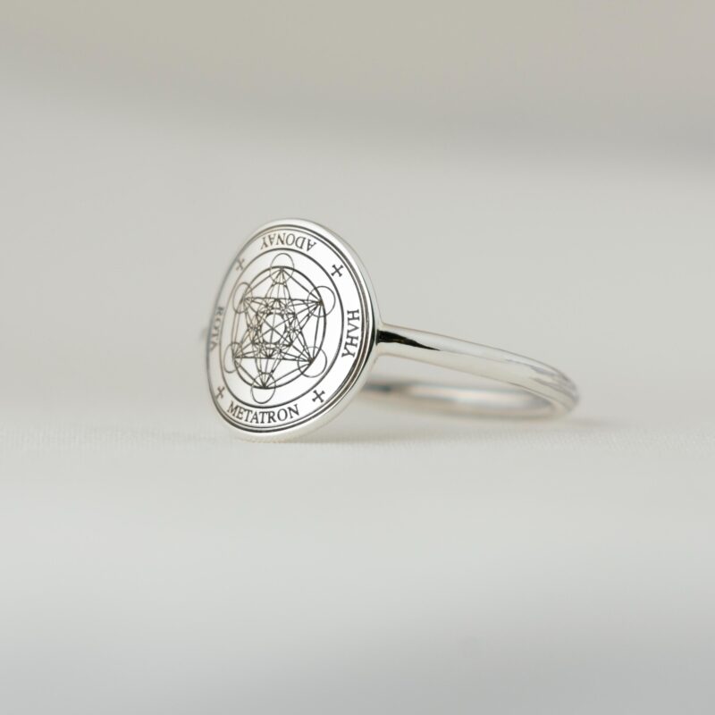 A detailed side angle of the Metatron silver ring, highlighting the geometric symmetry of the engraved cube. The sacred lines and names remain crisp against the shiny silver surface, showcasing the minimalist band and the delicate craftsmanship. A beautiful symbolic ring designed for spiritual alignment and daily wear.